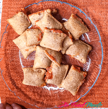 pile of cooked Totino Pizza Rolls on glass plate