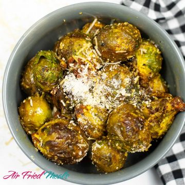 bowl of air fried Brussel sprouts with parmesan on it.