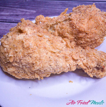 two pieces of fried chicken on a plate.