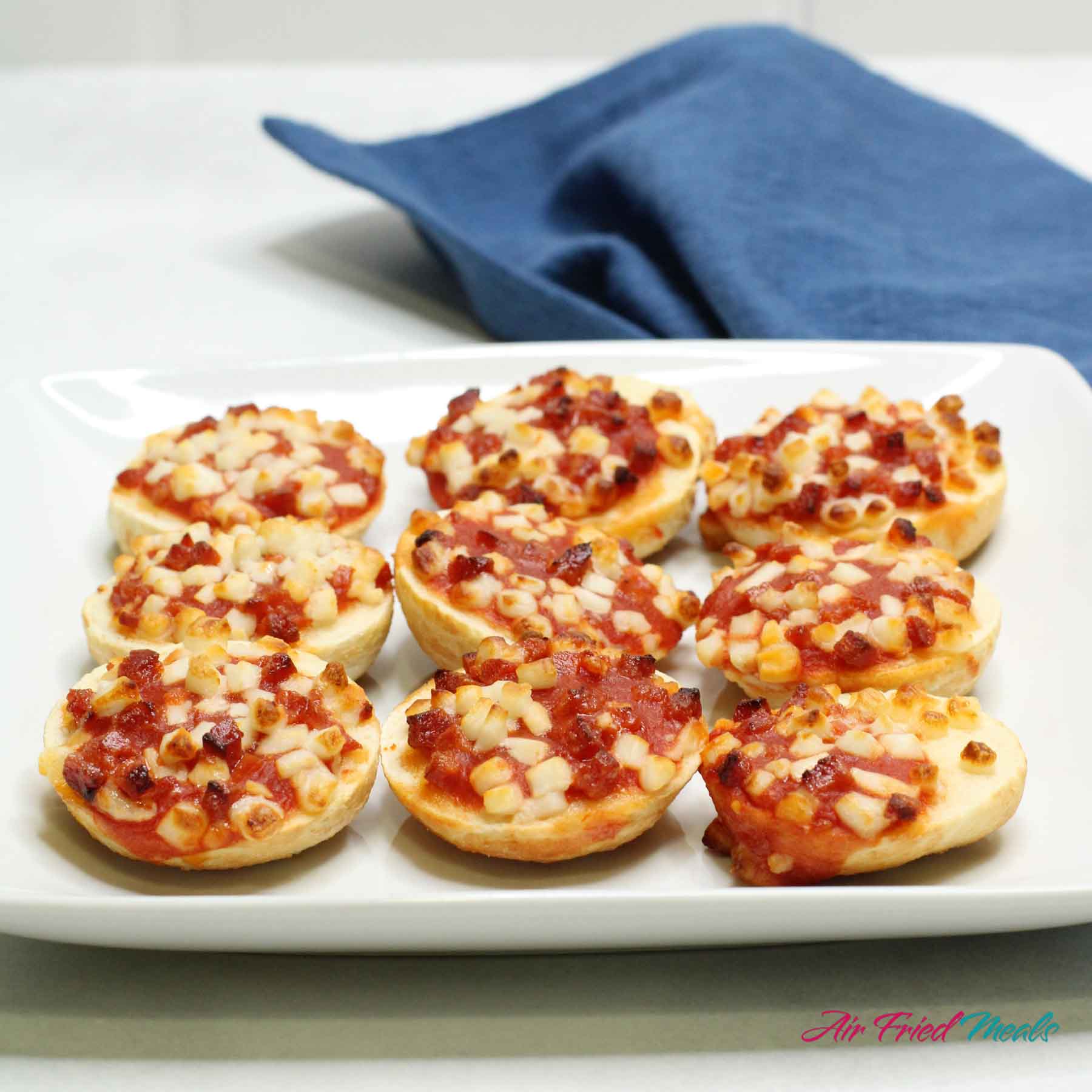 Air fried bagel bites on a plate.