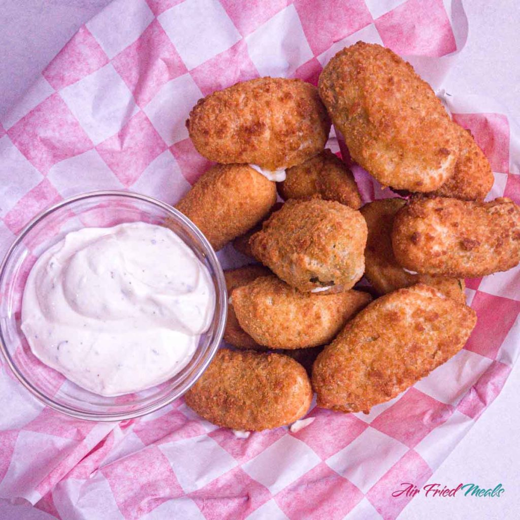 top down view of jalapeno poppers with small dish of ranch.