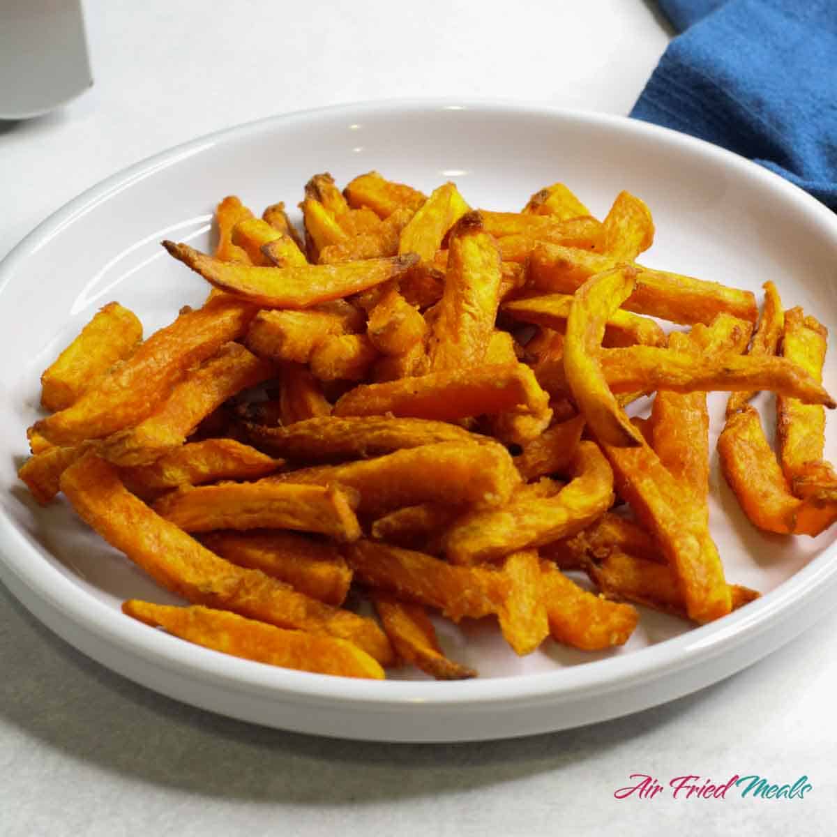 Air fryer frozen sweet potato fries on plate.