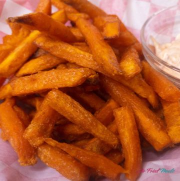 Closeup of a pile of cooked sweet potato fries.