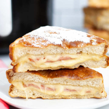 Monte Cristo Sandwich cut in half and stacked on a plate.