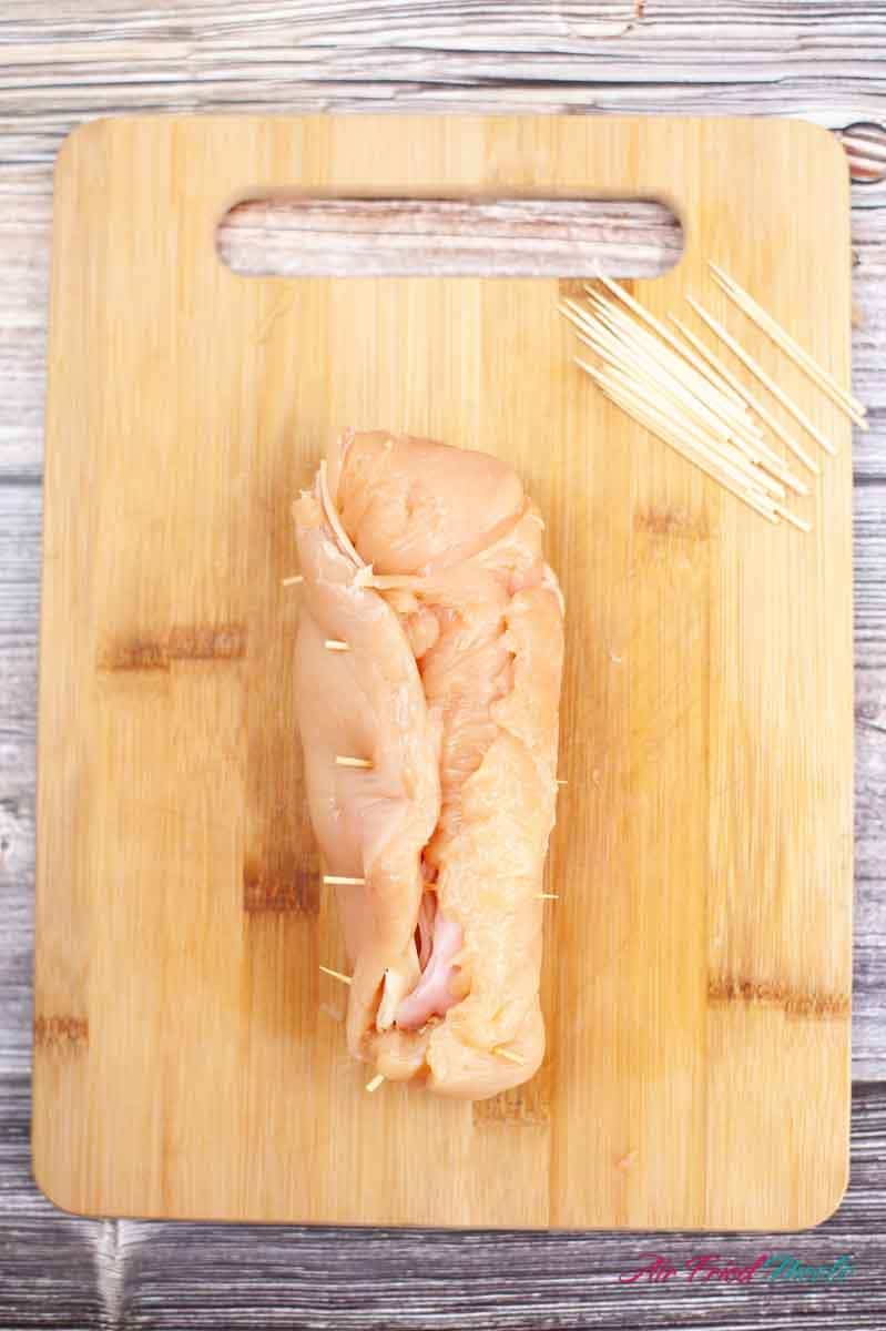 Chicken breast rolled up with toothpicks through it.