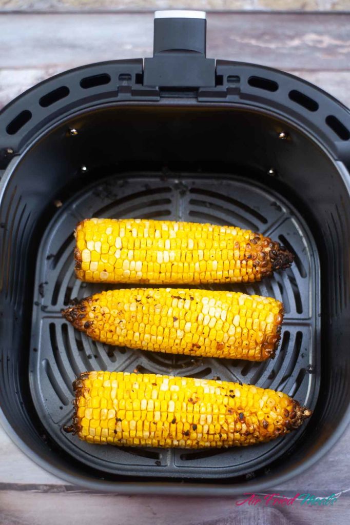 Air fried corn in air fryer basket.